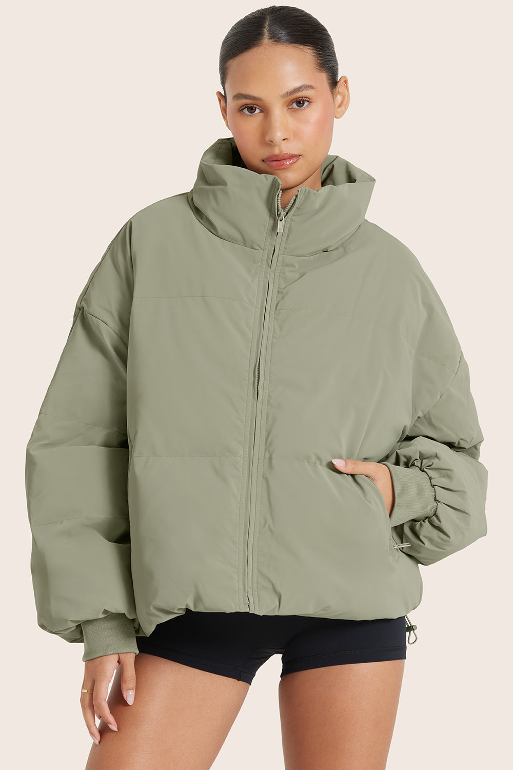 MODEL WEARS OVERSIZED PUFFER IN BONSAI