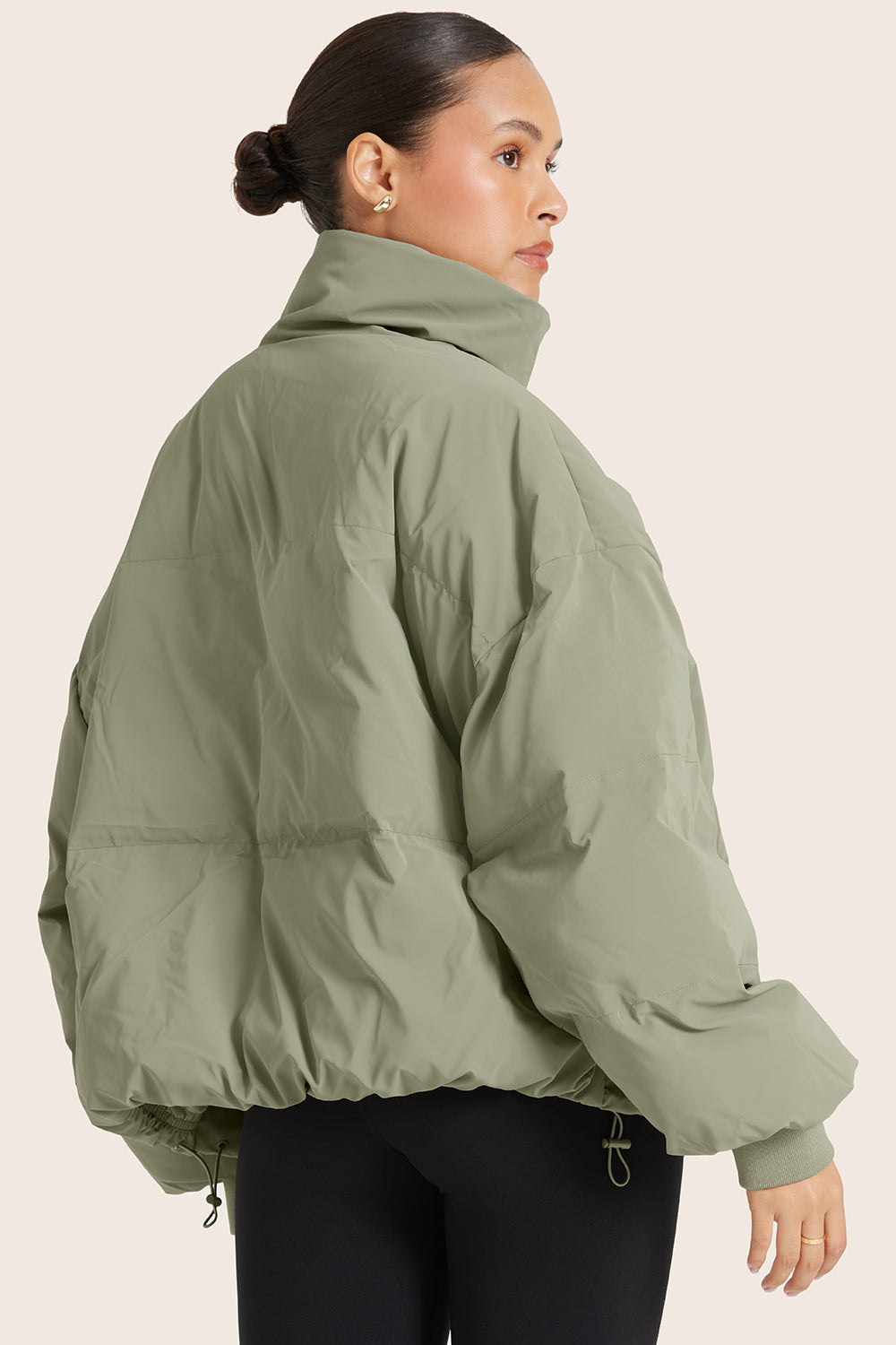 MODEL WEARS OVERSIZED PUFFER IN BONSAI