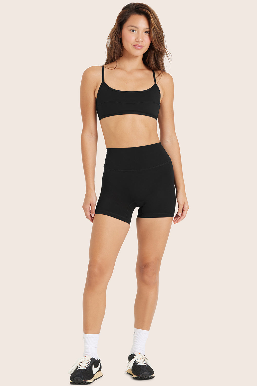 MODEL WEARS SPORTBODY® SPORTY SHORTS IN ONYX