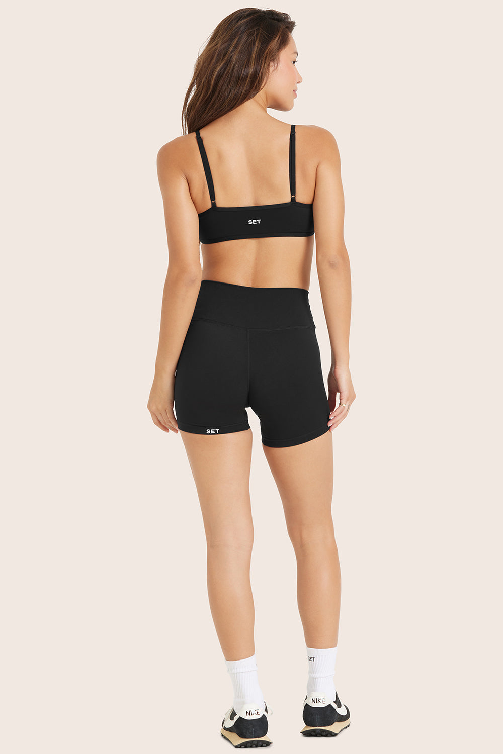 MODEL WEARS SPORTBODY® SPORTY SHORTS IN ONYX