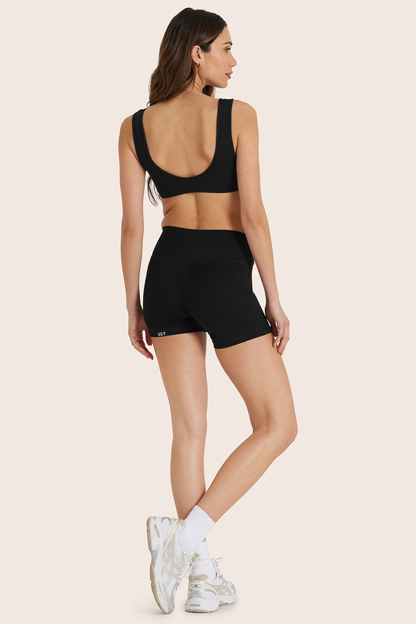 MODEL WEARS SPORTBODY® SPORTY SHORTS IN ONYX