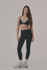 MODEL WEARS AIRLUXE™ BREATHE MID-RISE LEGGINGS IN ONYX