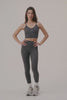 MODEL WEARS FORMCLOUD® CLOUD MID-RISE LEGGINGS IN PEPPER HEATHER GREY